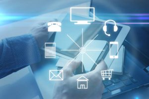 Hands with a tablet and different icons around. Omni channel Hands with a tablet and different icons around. Omni channel